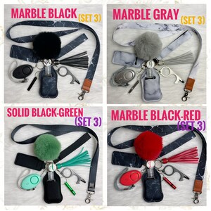 May include: Four sets of keychains with different color and pattern combinations. Each set includes a black lanyard, a black hand sanitizer holder, a black key ring, a black tassel, a black pom-pom, a silver whistle, a silver personal alarm, and a silver multi-tool. The sets include a black and white marble pattern, a gray and white marble pattern, a solid black and green pattern, and a black and red marble pattern.