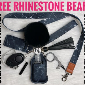 May include: A black and white marble patterned lanyard with a black pom-pom keychain, a black tassel, a black and white marble patterned hand sanitizer holder, a black personal alarm, a silver key ring, a silver bottle opener, and a silver keychain with the letter "M" on it.  FREE RHINESTONE BEAR? SILICONE KEYRING? TASSEL KEYCHAIN?