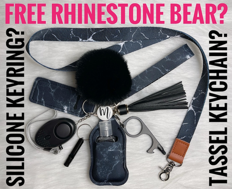 May include: A black and white marble patterned lanyard with a black pom-pom keychain, a black tassel, a black and white marble patterned hand sanitizer holder, a black personal alarm, a silver key ring, a silver bottle opener, and a silver keychain with the letter "M" on it.  FREE RHINESTONE BEAR? SILICONE KEYRING? TASSEL KEYCHAIN?