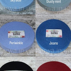 May include: Six spools of cotton webbing in various colors, including sky blue, dusty mint, periwinkle, jeans, black, and pomegranate. Each spool has a label with the word "BARWA" printed on it.