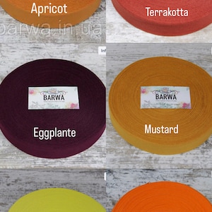 May include: Six spools of cotton webbing in different colors: apricot, terracotta, eggplant, mustard, lemon, and orange. Each spool has a label with the word "BARWA" printed on it.