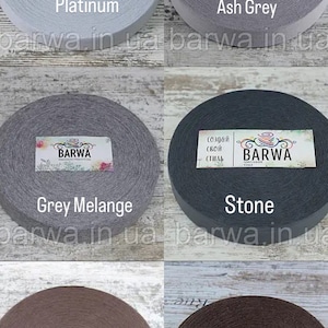 May include: Six spools of fabric in different colors, including platinum, ash grey, grey melange, stone, kakao, and arabika. Each spool has a label with the word "BARWA" and the color name.