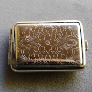 Classic Pill case of German Silver. Paris design holds pills and supplements neatly and secure.  Elegant but sturdy and crush proof.