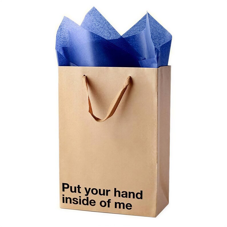 A brown paper shopping bag with blue tissue paper and the text "Put your hand inside of me" printed on it.