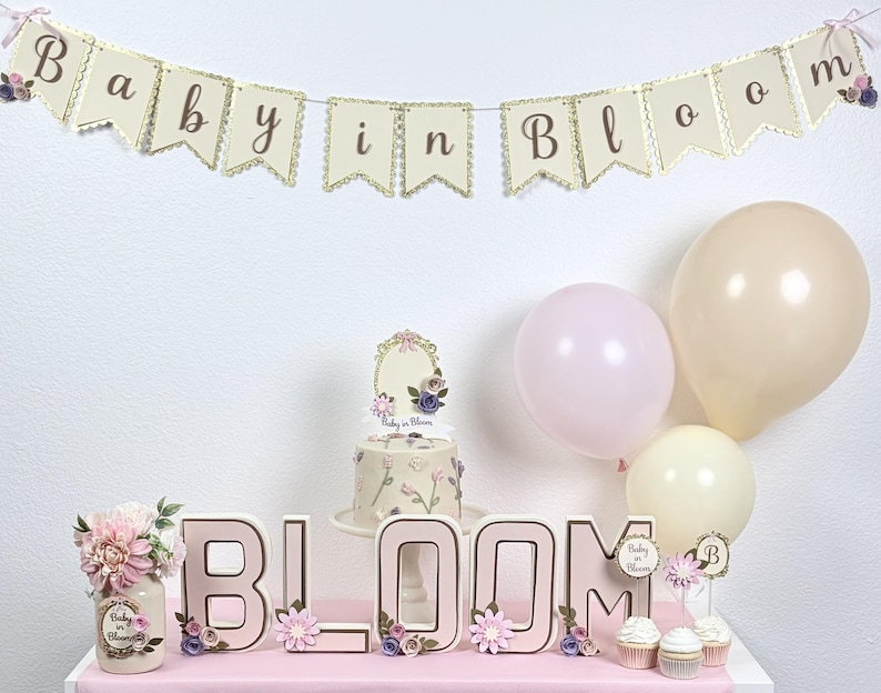 baby in bloom baby shower table setup with matching banner and decorations in pink floral theme