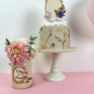 angled view of baby in bloom mason jar centerpiece with pink roses and greenery detail