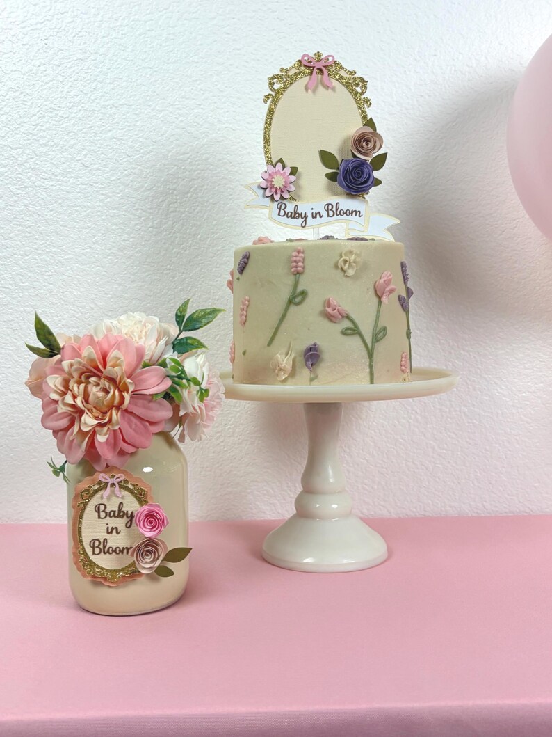 angled view of baby in bloom mason jar centerpiece with pink roses and greenery detail