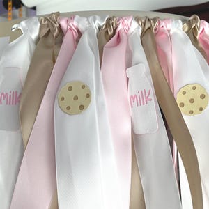 Close-up of milk and cookies highchair banner showing cardstock pieces and ribbon