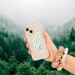 May include: A white iPhone case with a quote from John Muir: "And into the forest I go to lose my mind and find my soul."
