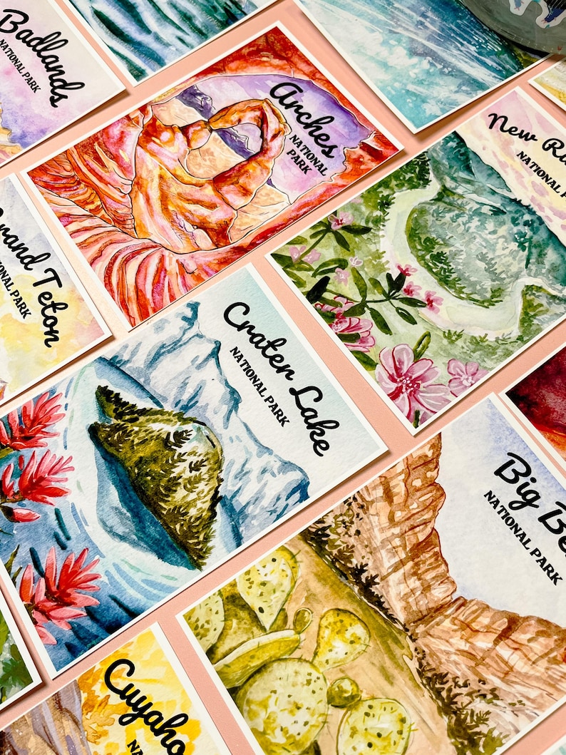 May include: A collection of watercolor paintings depicting various national parks in the United States. The paintings feature iconic landmarks and natural features, such as the Delicate Arch in Arches National Park, the Grand Teton in Grand Teton National Park, and Crater Lake in Crater Lake National Park.