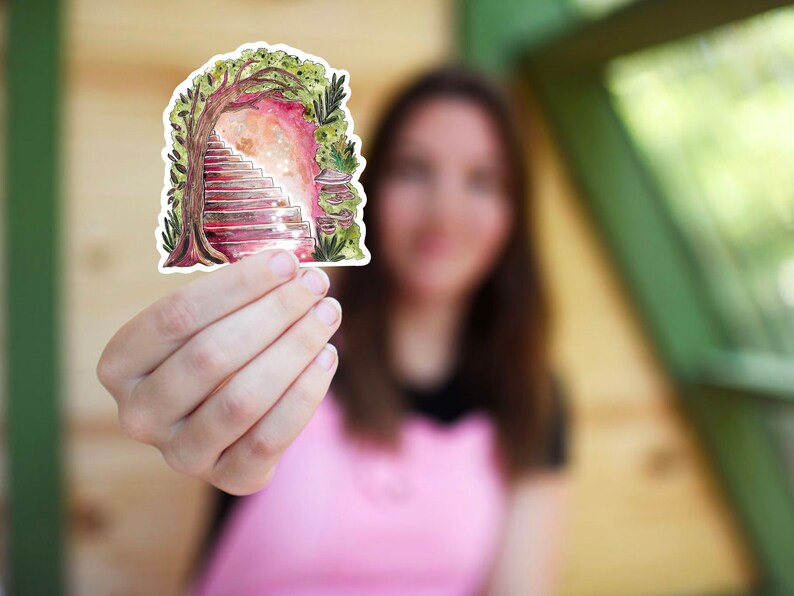 May include: A whimsical sticker featuring a watercolor illustration of a staircase leading into a glowing portal, framed by a tree and foliage. The artwork uses shades of pink, red, and green, creating a fantasy theme.