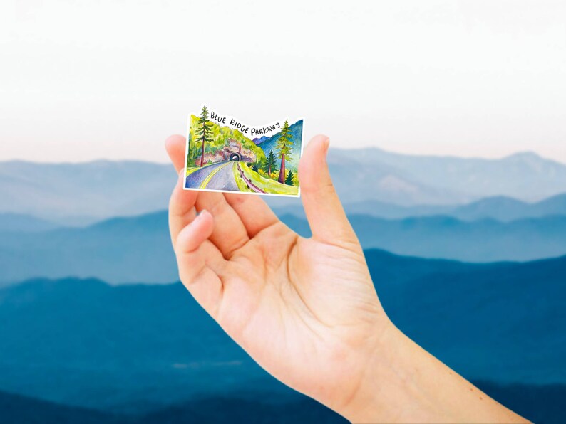 May include: A watercolor illustration of a scenic road with a tunnel, surrounded by trees and mountains. The text "Blue Ridge Parkway" is written in black at the top of the image.
