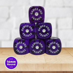 May include: A pyramid stack of six translucent purple dice with rounded corners. Each die face features the white text GAMES AND FRAMES arranged in a circle around a central white dot. A circular purple label in the corner displays 16mm Round.
