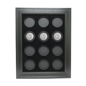 May include: Black wooden frame with a black velvet mat and 12 round coin display slots. Three silver coins are displayed in the center slots.