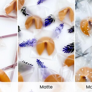 May include: Close-up of fortune cookies in clear, matte, and dotted packaging. The cookies are golden brown and individually wrapped. Some packages have lavender sprigs or gray bows. The text at the bottom reads "Clear", "Matte", and "Matte with dots".