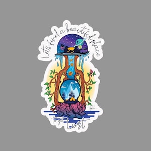 May include: A sticker with a colorful illustration of a tree with a crystal ball inside. The tree is surrounded by flowers and water. The text "Let's find a beautiful place to get lost" is written around the tree.