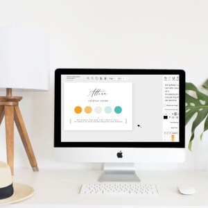May include: A computer screen displaying a wedding invitation design template with the text "Attire - Cocktail Attire". The design includes a color palette of orange, yellow, light blue, and teal.