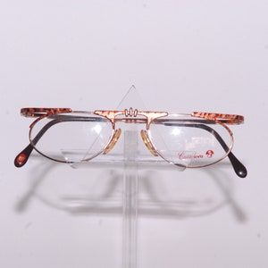 Casanova prestigeous eyewear, original form with aluchromic engravings, classic gold color, designed by Casanova in Italy