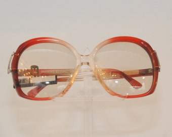 Jacques Esterel lovely eye-wear/sunglasses, attractive  form with metallic branches insertion, transducent-red color made in France