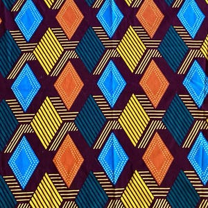 May include: A fabric with a repeating geometric pattern. The design features diamonds in blue, orange, and teal, with yellow diagonal stripes and white lines, set against a dark purple background. The pattern is symmetrical and visually striking.