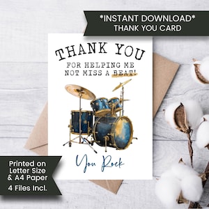May include: A thank you card featuring a blue and gold watercolour drum kit illustration. The card says "THANK YOU" and "FOR HELPING ME NOT MISS A BEAT!" with "You Rock" written in a script font. The card is printed on A4 paper.