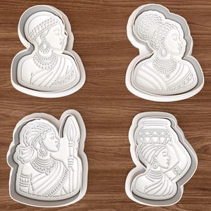 May include: Four white plastic cookie cutters featuring detailed profiles of African women. Each cutter depicts a different hairstyle and attire, including jewelry and head wraps. The cutters are designed for baking and crafting.