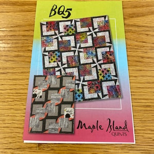 May include: A quilting pattern with a colorful floral design and black and white geometric shapes. The pattern is titled "BQ5" and is from Maple Island Quilts.