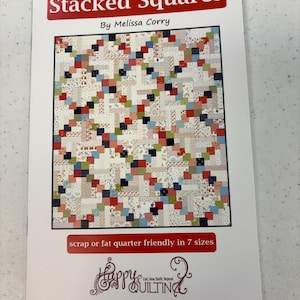 May include: A white paper with the title "Stacked Squares" in a red banner. The image shows a quilt pattern with colourful squares. The text "By Melissa Corry" is below the title. The bottom of the paper has the text "scrap or fat quarter friendly in 7 sizes" and the "Happy Quilting" logo.