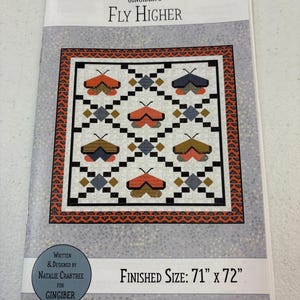May include: A quilting pattern for a quilt titled "Fly Higher" by Natalie Crabtree for Gingiber. The quilt features a geometric design with colourful butterflies and a finished size of 71 inches by 72 inches.