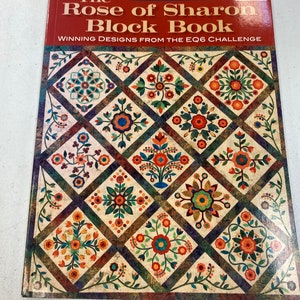 May include: The Rose of Sharon Block Book by Sharon Pederson, featuring winning designs from the EQ6 Challenge. The book cover showcases a quilt with a patchwork design of colorful floral patterns.