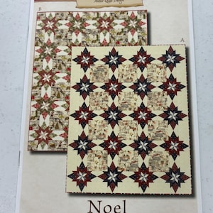 May include: A printed fabric design featuring two quilt patterns. One pattern has a repeating star design with red, white, and blue accents. The other pattern has a repeating star design with a Christmas theme. The word "Noel" is printed at the bottom.