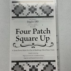 May include: A clear acrylic quilting ruler labeled Four Patch Square Up by Studio 180 Design. The packaging features black and white graphics of quilt blocks, text detailing simple centering, high precision for 12 sizes, and instructions.