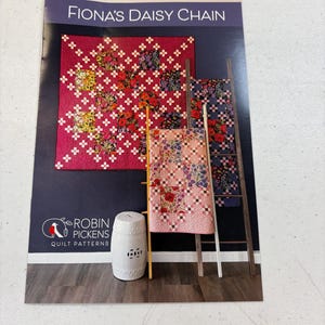 May include: A quilt pattern booklet featuring a floral design with the title "Fiona's Daisy Chain" and the logo "Robin Pickens Quilt Patterns".