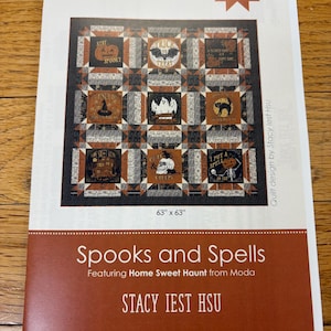 May include: A quilting pattern for a Halloween quilt called "Spooks and Spells" featuring the Home Sweet Haunt fabric line by Stacy Iest Hsu. The quilt is 63 inches by 63 inches and features a variety of Halloween-themed blocks, including pumpkins, bats, ghosts, and witches.