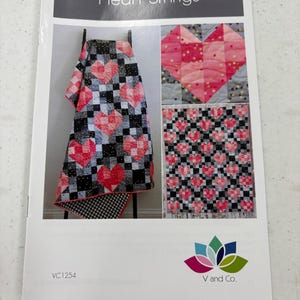 May include: A printed pattern titled "Heart Strings" featuring quilt designs with heart motifs. The designs showcase quilts with red and pink hearts on black and white checkered backgrounds. The pattern includes a logo for V and Co. and the code VC1254.