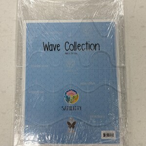 May include: A light blue Wave Collection product, wrapped in clear plastic. The product features the text "Wave Collection" and "Made in the USA". The design includes wave patterns and the brand name "Sariditty".