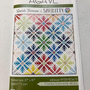 May include: A quilt pattern called "Agave" by Sarah Thomas of Sariditty. The pattern features a colorful geometric design with a finished size of 87 inches by 87 inches. The skill level is intermediate and uses foundation paper piecing.