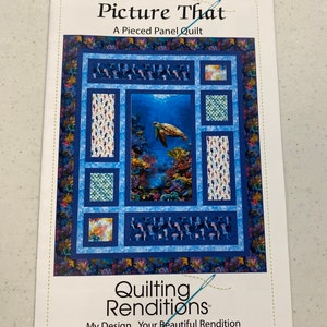 May include: A quilting pattern titled "Picture That" featuring a sea turtle swimming in a blue ocean with coral reefs. The pattern is a pieced panel quilt and is part of the "Quilting Renditions" series. The text "My Design...Your Beautiful Rendition" is also included.