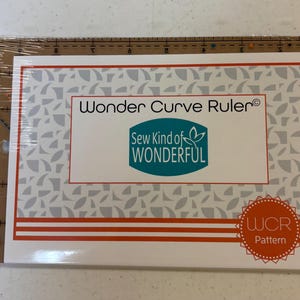 May include: A white Wonder Curve Ruler pattern with a teal logo that says "Sew Kind of WONDERFUL" and a red and white logo that says "WCR Pattern".
