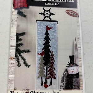 May include: A quilting pattern for a wall hanging featuring cardinals in winter trees. The pattern is 6 1/2 inches by 21 inches and is rated as intermediate skill level. The pattern is from Patch Abilities, Inc.