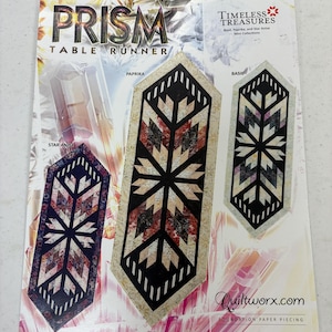 May include: A magazine cover featuring three colorful table runner designs. The designs are labeled "Star Anise", "Paprika", and "Basil". The cover also includes the text "PRISM TABLE RUNNER" and "Timeless Treasures Mini Collections".