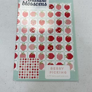 May include: A quilt pattern booklet with a red and white strawberry design. The title is "Berry Picking" and the text says "A 75" berry quilt and mini".
