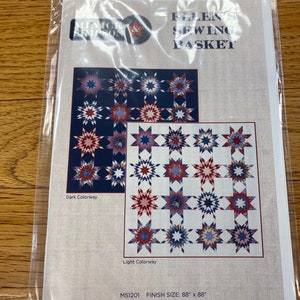 May include: A quilting pattern for a quilt called "Ellen's Sewing Basket" by Minick & Simpson. The pattern shows two colorways of the quilt, one in dark colors and one in light colors. The quilt is made up of a grid of stars. The finished size of the quilt is 88 inches by 88 inches.