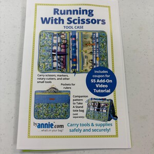 May include: A brochure titled "Running With Scissors TOOL CASE" features a tool case with pockets for scissors, markers, rotary cutters, and rulers. The brochure includes a coupon for a video tutorial and information about a companion tote bag.