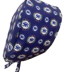 May include: A navy blue surgical scrub cap featuring a repeating pattern of the Chelsea Football Club logo. The logo is a circular design with a lion and the words "CHELSEA FOOTBALL CLUB" in white. The cap has ties.