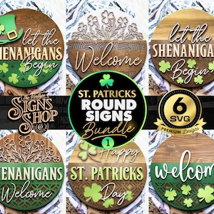 May include: Six round wooden signs with a St. Patrick's Day theme. The signs feature green shamrocks, the text "Let the Shenanigans Begin", "Welcome", "Happy St. Patrick's Day", and "Shenanigans Welcome".