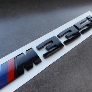 BMW M335i embleem, glanzend zwart, nieuw in folie, opschrift M240i, M540i, M550i, M535i, M235i, M435i, M140i, M550d, M750d, M335i...