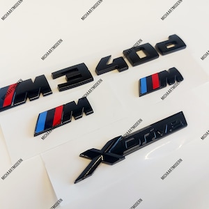 Bmw M340d set, 2 x M emblem for the fenders (45 x 15 mm) + M 340d trunk + Xdrive black shiny new item in foil, lettering, badge