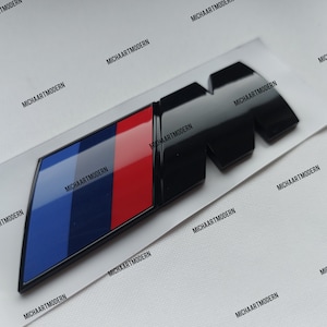 Emblemat BMW M czarny błyszczący nowy w folii, 90 x 30 mm, pasujący do napisu na bagażniku Nowość .....