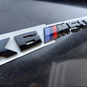 BMW X6M50d emblem, glossy black, new in foil, lettering